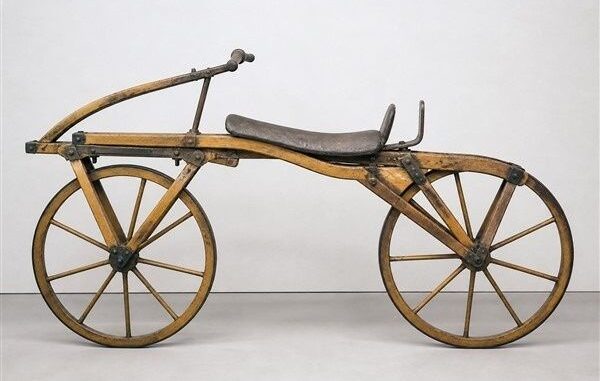 Historisches zweirädriges Holzfahrrad mit Sattel und großen Speichenrädern